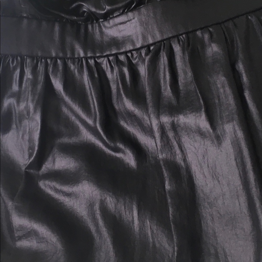 Black top with extendable spaghetti straps.